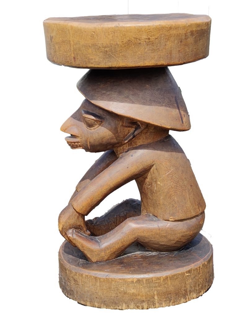 Nigerian Joruba stool, seated capped figure side view