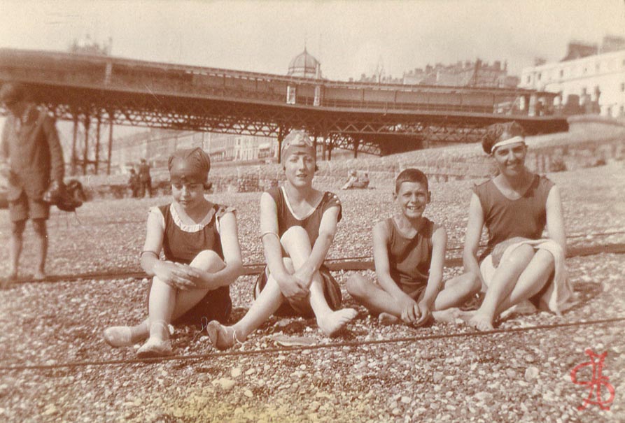 4 bathers with headgear in front of Brighton pier 1920s