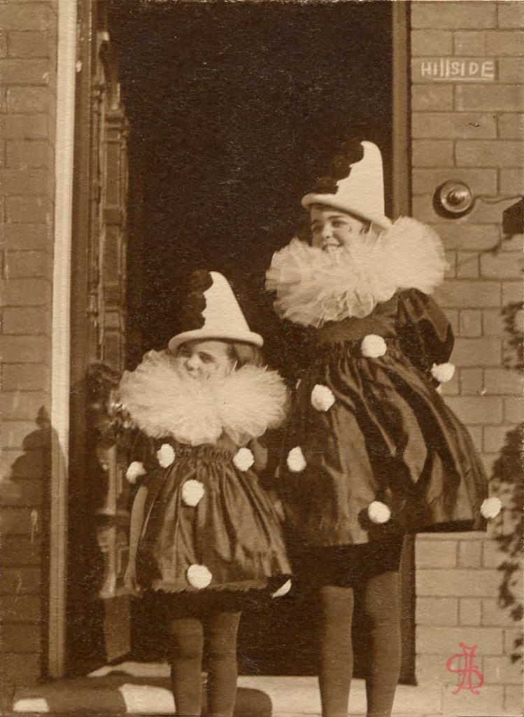 Two girls in Pierrot costumes in front of Hillside 125 Harrow View